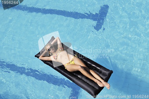 Image of beautiful woman relax on swimming pool