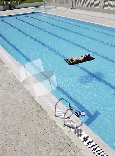 Image of beautiful woman relax on swimming pool