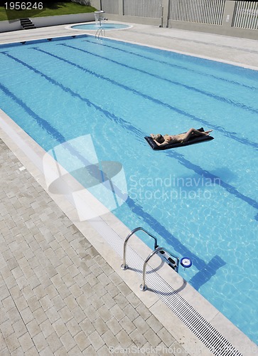 Image of beautiful woman relax on swimming pool