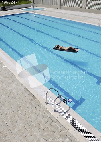 Image of beautiful woman relax on swimming pool
