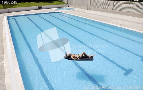 Image of beautiful woman relax on swimming pool