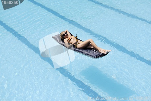 Image of beautiful woman relax on swimming pool
