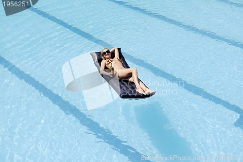 Image of beautiful woman relax on swimming pool