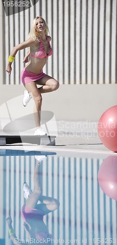 Image of woman fitness exercise at poolside