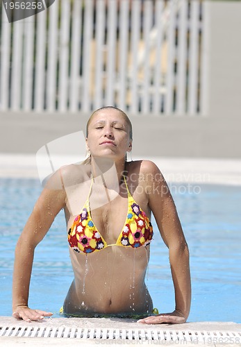 Image of beautiful woman relax on swimming pool