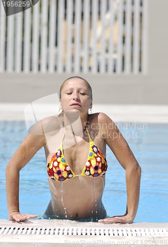 Image of beautiful woman relax on swimming pool