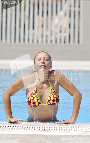 Image of beautiful woman relax on swimming pool