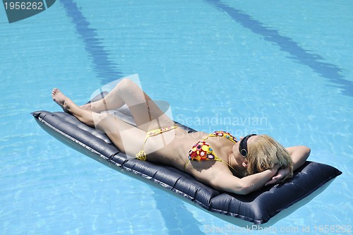 Image of beautiful woman relax on swimming pool
