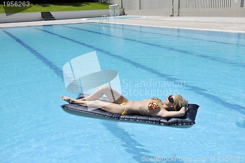 Image of beautiful woman relax on swimming pool