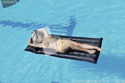 Image of beautiful woman relax on swimming pool
