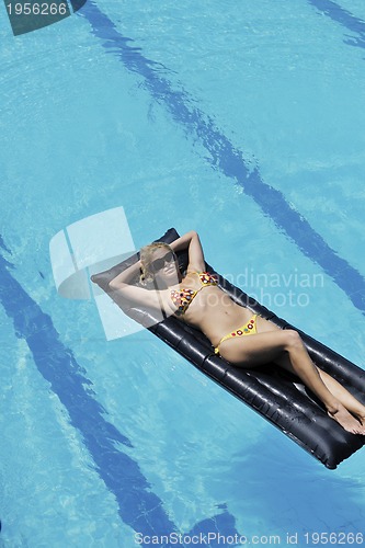 Image of beautiful woman relax on swimming pool