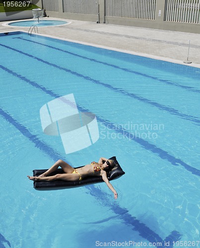 Image of beautiful woman relax on swimming pool