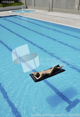Image of beautiful woman relax on swimming pool