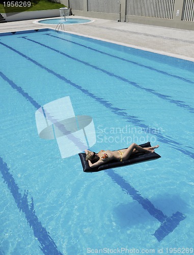 Image of beautiful woman relax on swimming pool