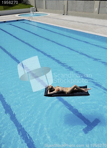 Image of beautiful woman relax on swimming pool