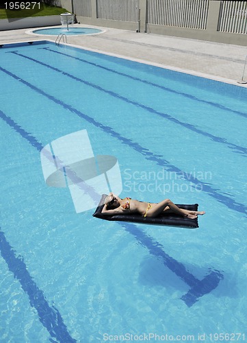 Image of beautiful woman relax on swimming pool