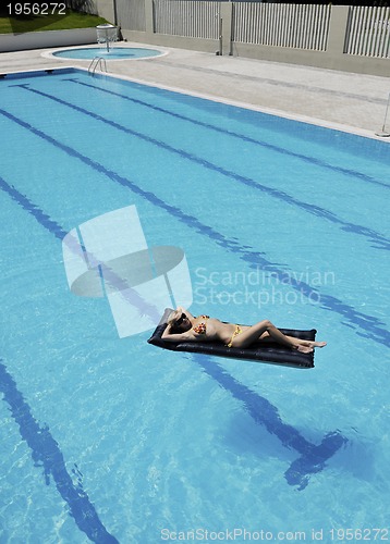 Image of beautiful woman relax on swimming pool