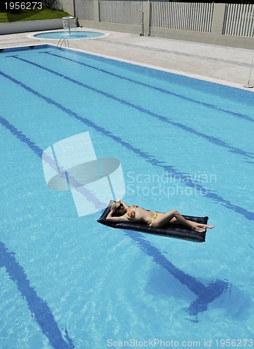 Image of beautiful woman relax on swimming pool