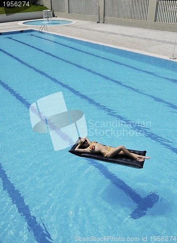 Image of beautiful woman relax on swimming pool