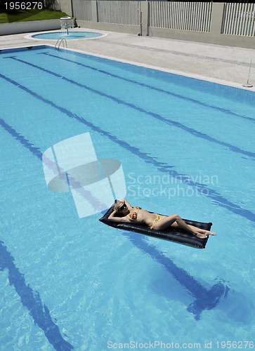 Image of beautiful woman relax on swimming pool