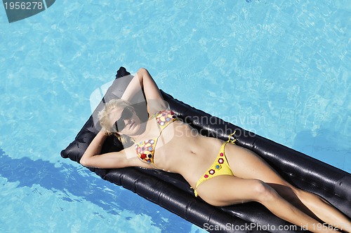 Image of beautiful woman relax on swimming pool