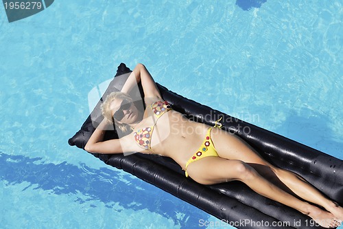 Image of beautiful woman relax on swimming pool