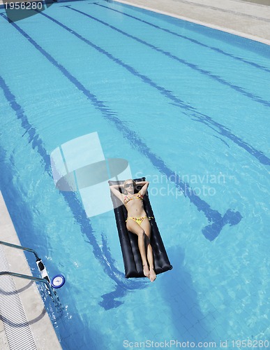Image of beautiful woman relax on swimming pool