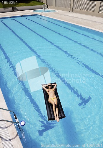 Image of beautiful woman relax on swimming pool