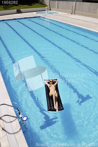 Image of beautiful woman relax on swimming pool