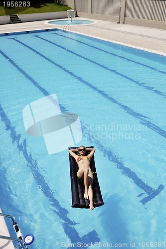 Image of beautiful woman relax on swimming pool