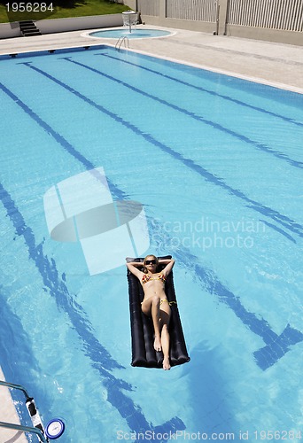 Image of beautiful woman relax on swimming pool