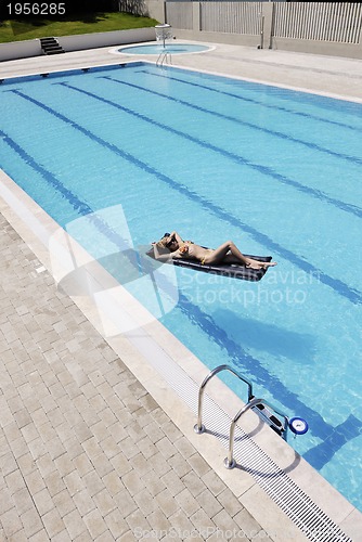 Image of beautiful woman relax on swimming pool