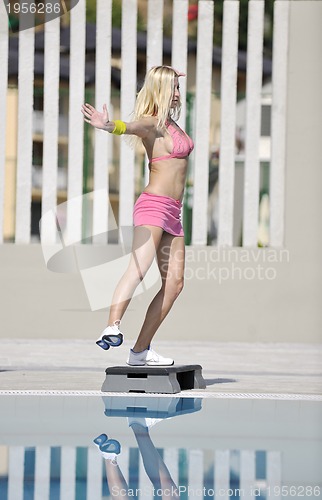 Image of woman fitness exercise at poolside