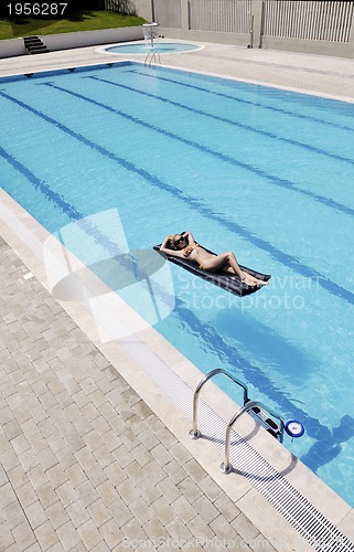 Image of beautiful woman relax on swimming pool