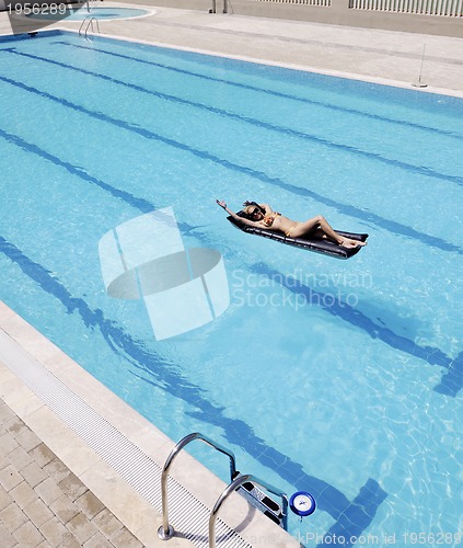 Image of beautiful woman relax on swimming pool