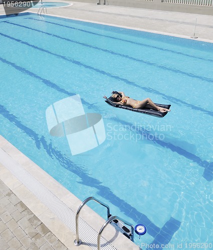 Image of beautiful woman relax on swimming pool