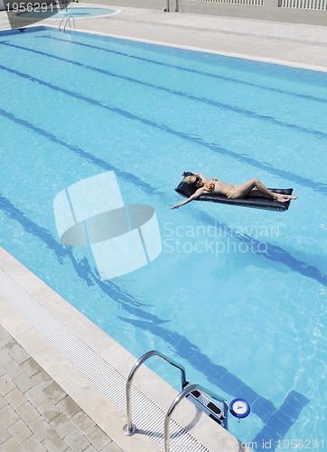 Image of beautiful woman relax on swimming pool