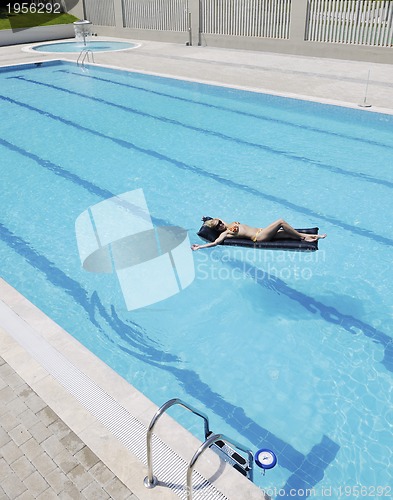 Image of beautiful woman relax on swimming pool