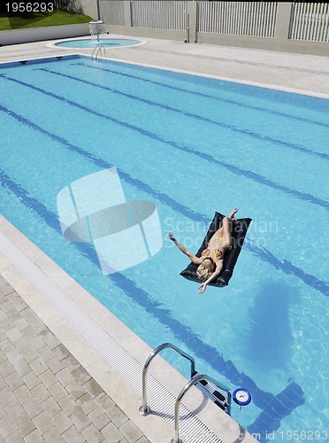 Image of beautiful woman relax on swimming pool