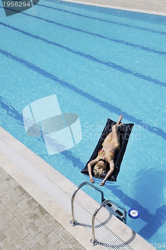 Image of beautiful woman relax on swimming pool