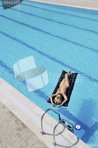 Image of beautiful woman relax on swimming pool