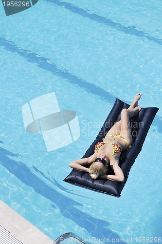Image of beautiful woman relax on swimming pool