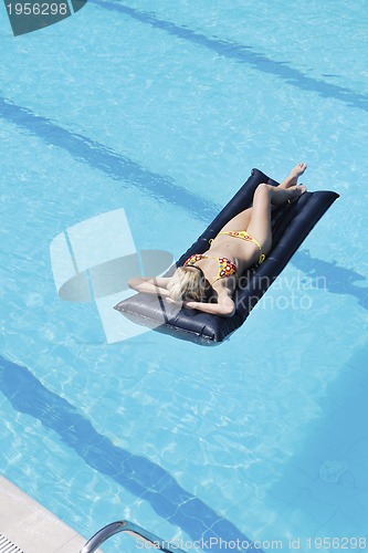 Image of beautiful woman relax on swimming pool