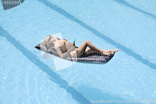 Image of beautiful woman relax on swimming pool