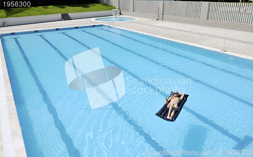 Image of beautiful woman relax on swimming pool