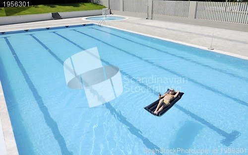 Image of beautiful woman relax on swimming pool