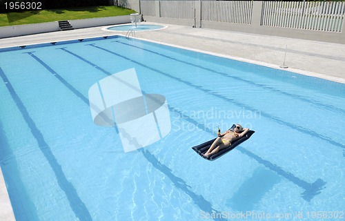 Image of beautiful woman relax on swimming pool