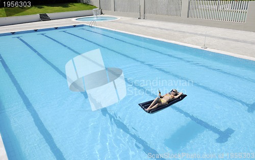 Image of beautiful woman relax on swimming pool