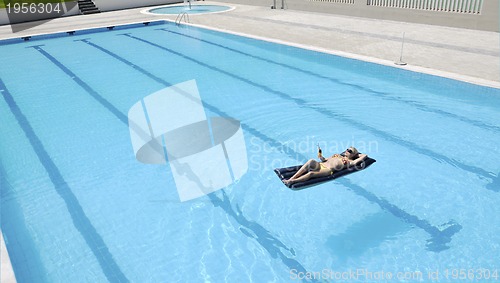 Image of beautiful woman relax on swimming pool