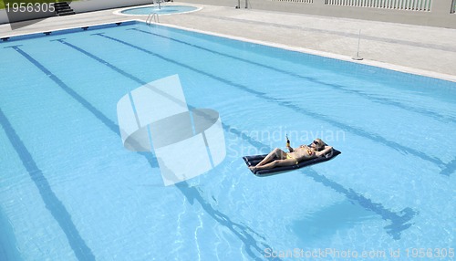 Image of beautiful woman relax on swimming pool